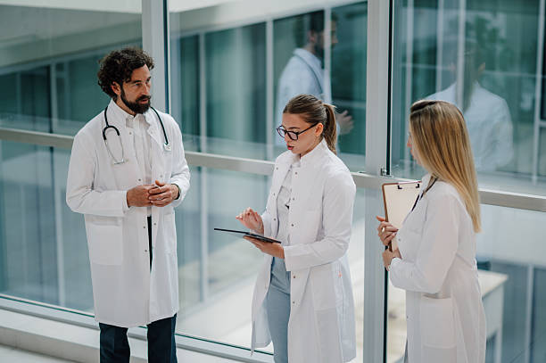 istock Medical team discussing patient information using digital tablet in hospital corridor 2223733881