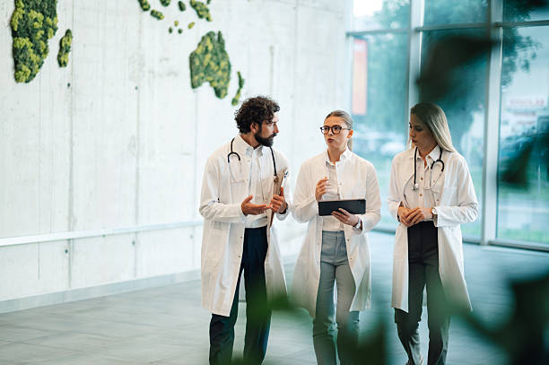 istock Doctors walking and discussing patient cases in modern hospital 2223733889