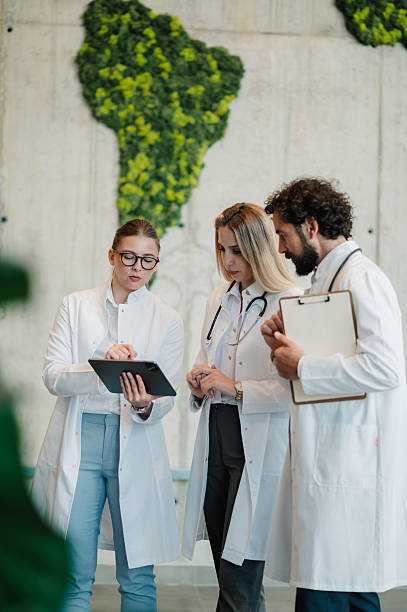 istock Doctors discussing patient data using digital tablet in hospital corridor 2223733891