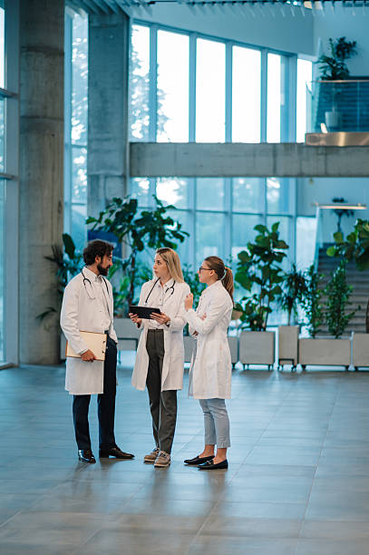 istock Doctors discussing patient data using tablet in hospital lobby 2223733907