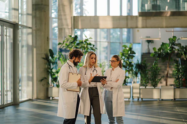 istock Doctors using tablet and clipboard discussing diagnosis in hospital lobby 2223733912