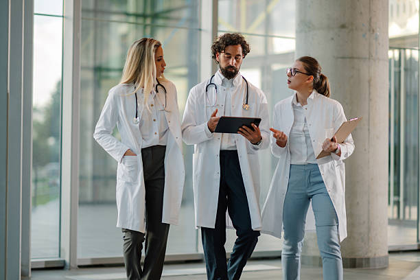 istock Doctors walking and discussing over digital tablet in hospital corridor 2223733952