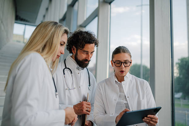 istock Medical team analyzing patient data on digital tablet in hospital 2223733982