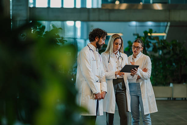 istock Medical team analyzing patient data on digital tablet in hospital lobby 2223733991