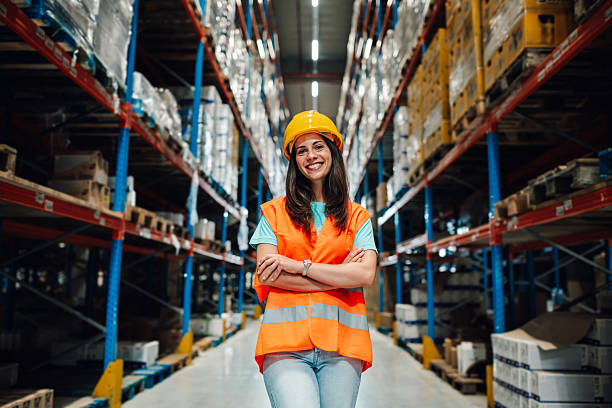 istock Smiling warehouse worker standing with crossed arms in a storage room 2223734055