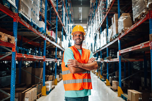 istock Warehouse worker smiling with arms crossed in a storage room 2223734059