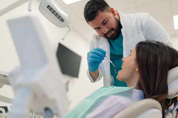 istock Dentist examining patient's teeth in modern dental clinic 2223734142
