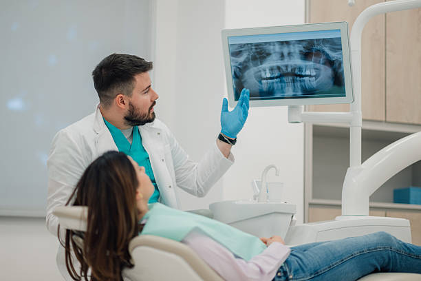 istock Dentist showing teeth x-ray to patient in clinic 2223734167