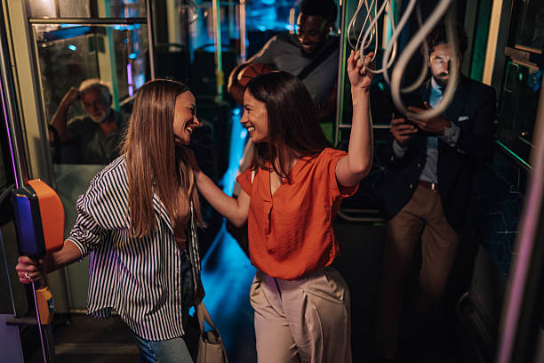 istock Two young women talking and having fun on a night bus ride 2223734385