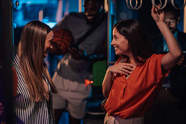 istock Two young women talking and having fun on a night bus ride 2223734386