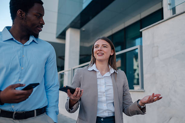 istock Business colleagues walking and talking outside office building 2223734665