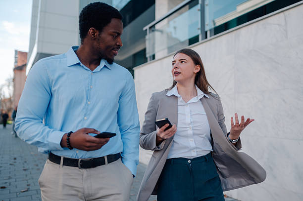 istock Businesspeople walking and talking outside office building 2223734667