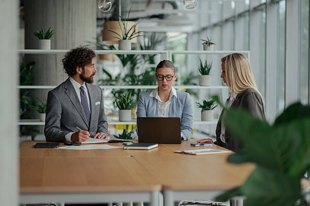 istock Businesspeople working together in modern office using laptop 2223734748