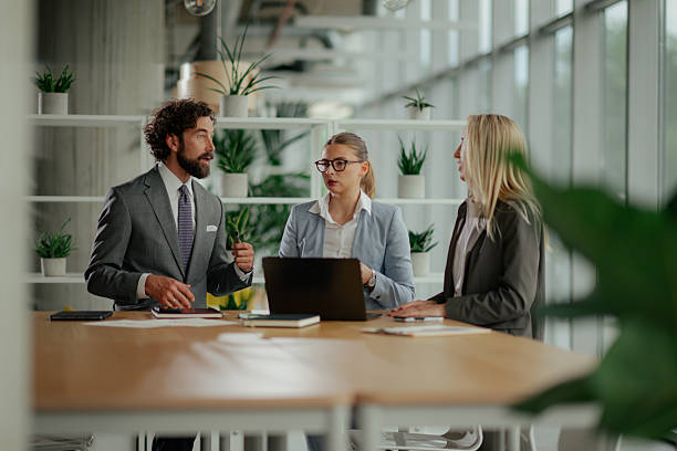 istock Business team discussing strategy at meeting table in modern office 2223734796