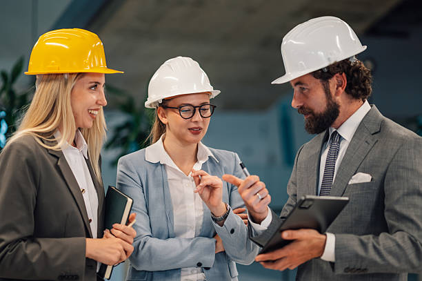 istock Engineers and architects discussing a project wearing hard hats 2223734947