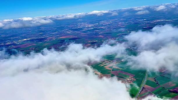 istock A Stunning Aerial View Showcasing Lush Green Fields Surrounded by Fluffy Clouds Above 2223740894