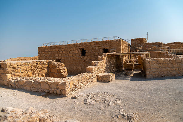 istock Ancient stone ruins stand against a clear blue sky, showcasing historical architecture and weathered textures. 2223742355