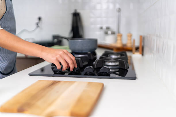 istock Chef turning on stove in a modern kitchen 2223742849