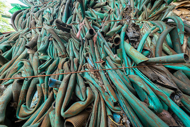 A densely packed pile of used, discarded rubber tires and shredded fragments, collected separately in a waste yard for recycling. The image highlights the massive volume of automotive waste and tire disposal challenges.