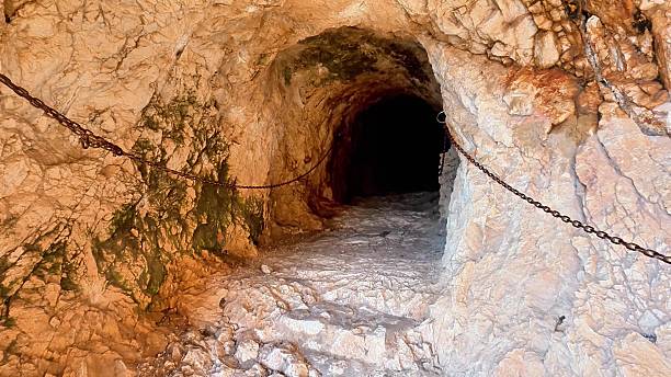 istock Exploring a mysterious cave tunnel with intriguing rock formations sparks adventure 2223744219