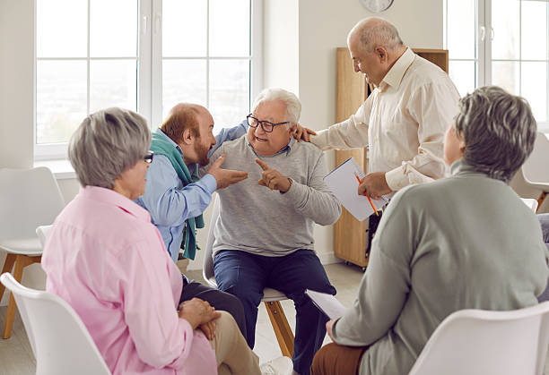 istock Two angry elderly people are talking and arguing at group therapy session meeting 2223744793