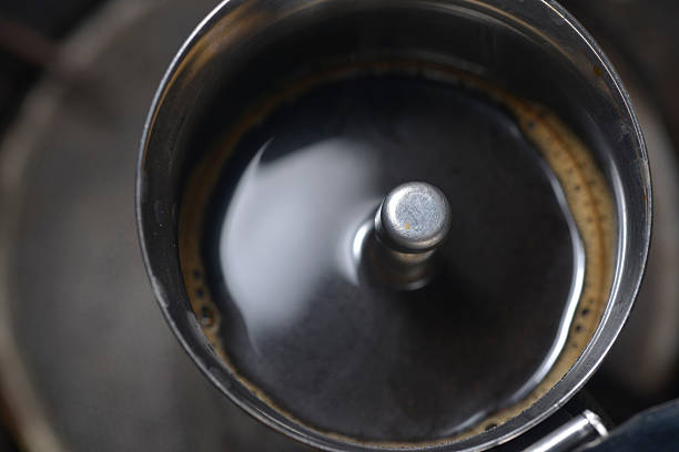 Intense, bubbling espresso inside moka pot, photographed from top angle