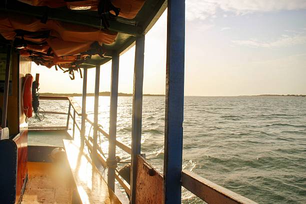 istock Side of a boat on the river water with sunset light being reflected 2223751205