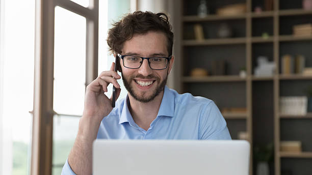 istock Smiling man holds smartphone leads talk to customers services manager 2223753399