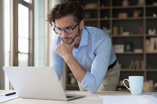 istock Pensive serious businessman looks at laptop screen 2223756057