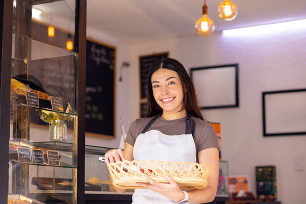 istock Woman bakery owner offering bread to the public 2223756315