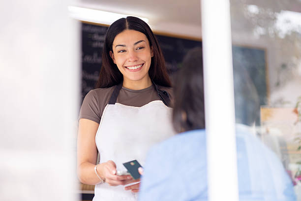 istock Female bakery owner receiving contactless payment 2223756366