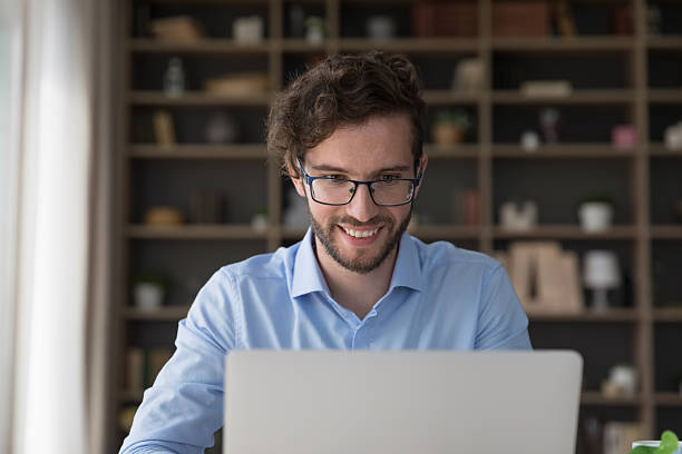 istock Satisfied millennial male freelancer typing on laptop 2223756561