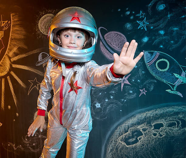 istock Smiling girl cosmonaut on a background with the outer space chalk drawing 2223757489