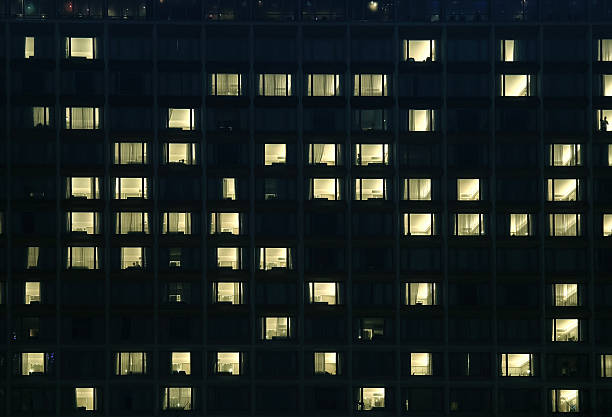 istock A tall building with many windows is beautifully lit up at night 2223758262