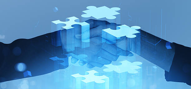 istock Business handshake with puzzle overlay symbolizing partnership and collaboration. 2223762591
