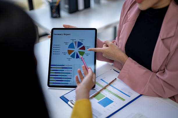 istock Businesswomen analyzing financial summary report on tablet 2223765348