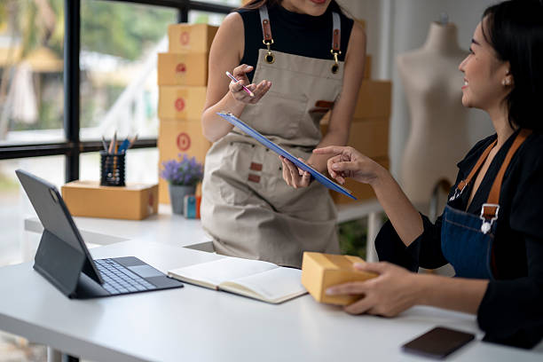 istock Two young businesswomen discussing a delivery checklist in a warehouse 2223765455