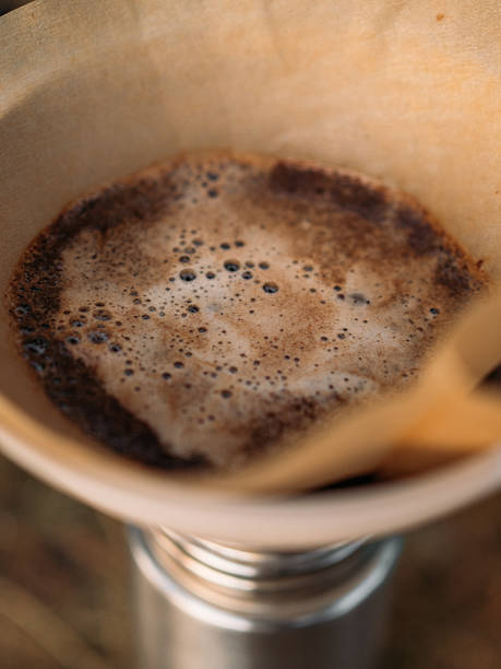 istock Close up of bubbling ground coffee inside paper filter during outdoor brew process 2223765743