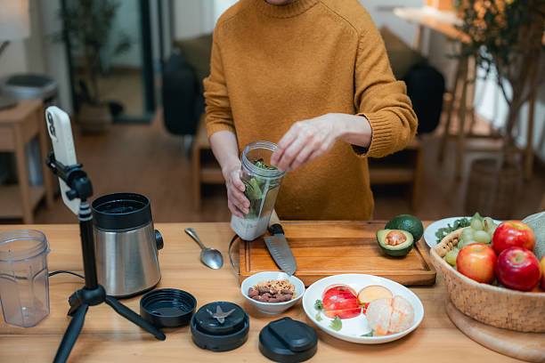 istock Senior woman content creator hosting a livestream from her home kitchen, sharing step-by-step how to make nutrient-rich green juice 2223766185