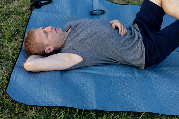 istock Man napping on a blanket outdoors 2223767977