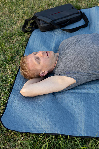 istock Man napping on a blanket outdoors 2223768032