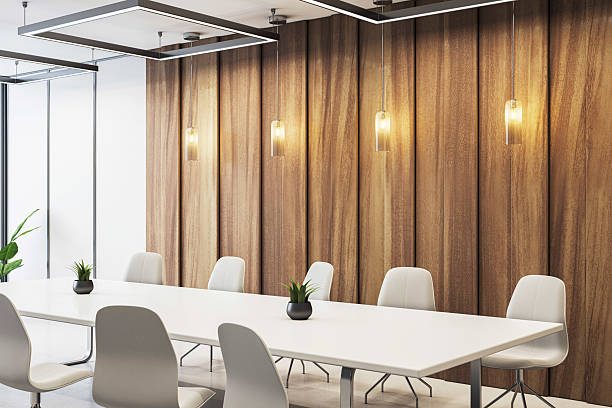 istock Modern empty conference room with white chairs, wooden wall panels, pendant lighting and minimalist decor in a corporate office interior setup. 3D Rendering 2223770984
