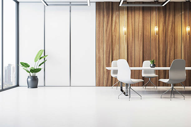 istock Modern minimalist conference room with wooden panel wall, white floor, sleek table, chairs, and potted plant near large city-view window. 3D Rendering 2223770985