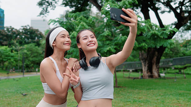 istock Two active women snapping selfies while hanging out in the park 2223772702