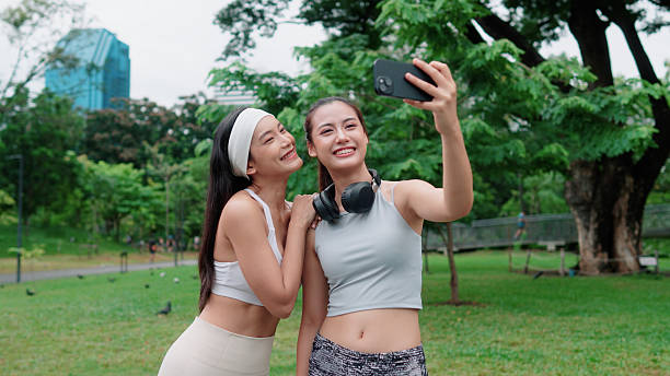 istock Two active women snapping selfies while hanging out in the park 2223772710