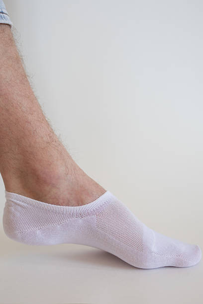 istock white sock with copy space on human foot close up photo on white background. 2223774296