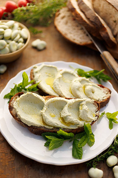 Broad bean spread sandwiches with olive oil on a white plate