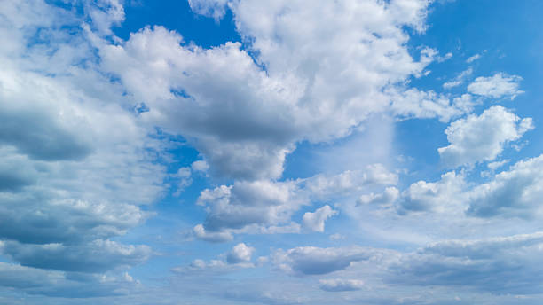 istock A vibrant sky filled with fluffy white clouds against a bright blue backdrop, showcasing the beauty of nature during a sunny day. Ideal for backgrounds and environmental themes. 2223775304