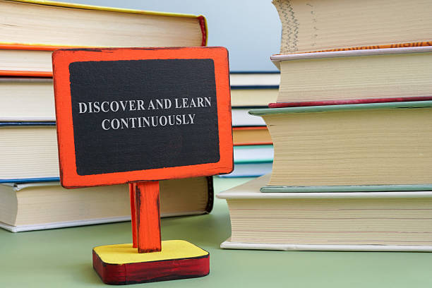 Books and sign with discover and learn continuously. Lifelong learning and personal growth.