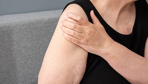 istock Female hand stroking forearm in pain 2223779840